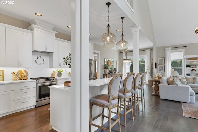 1720 W Meadows Dr NW, Salem, OR 97304 - kitchen with appliances with stainless steel finishes, open floor plan, a kitchen breakfast bar, light countertops, and tasteful backsplash