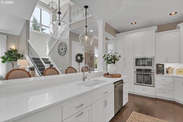 1720 W Meadows Dr NW, Salem, OR 97304 - kitchen with stainless steel appliances, a sink, hanging light fixtures, light countertops, and recessed lighting