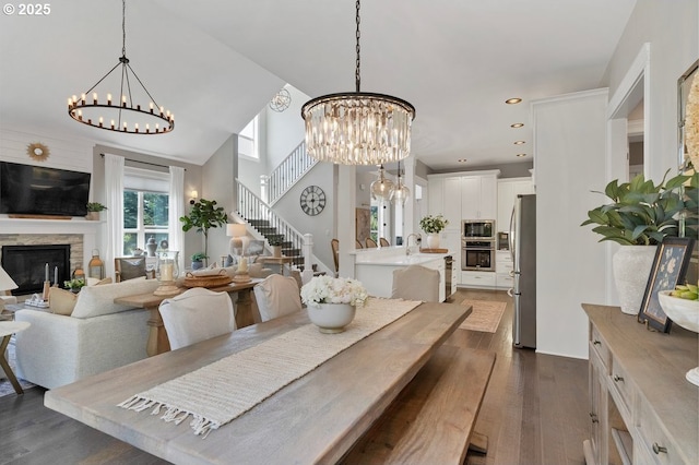 1720 W Meadows Dr NW, Salem, OR 97304 - dining area with a chandelier, dark wood finished floors, a stone fireplace, recessed lighting, and stairway