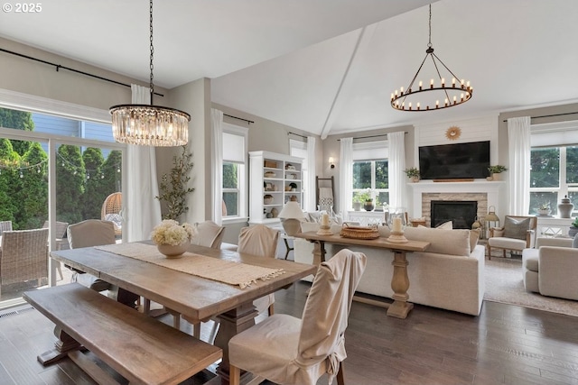 1720 W Meadows Dr NW, Salem, OR 97304 - dining area featuring a chandelier, a stone fireplace, dark wood-style floors, and lofted ceiling