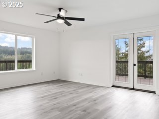 empty room featuring ceiling fan and light wood-type flooring