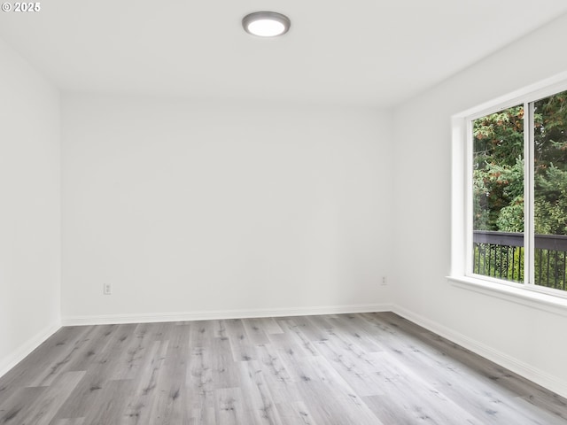 empty room with a healthy amount of sunlight and light wood-type flooring