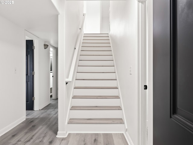 stairs with hardwood / wood-style floors