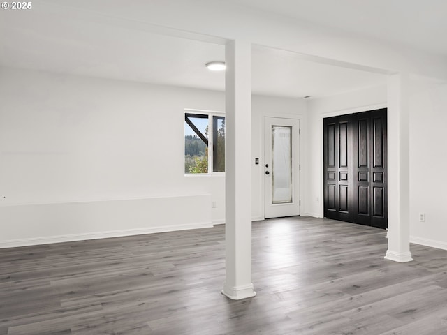 entryway featuring wood-type flooring and ornate columns