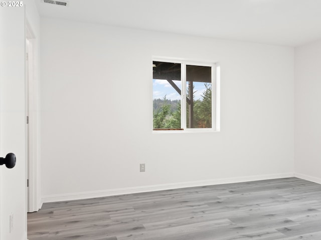 spare room featuring hardwood / wood-style flooring