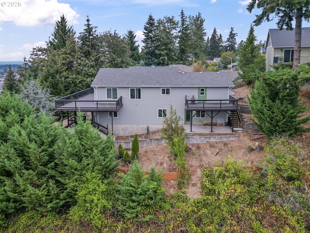 rear view of property featuring a wooden deck