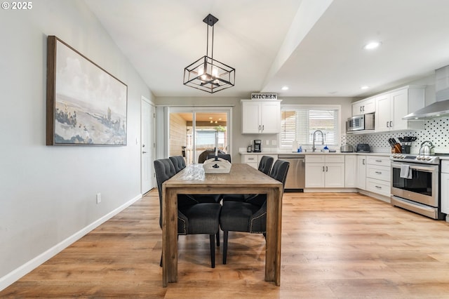 dining area with a wealth of natural light, recessed lighting, and light wood-style floors