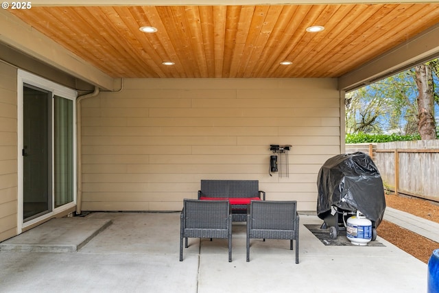 view of patio / terrace featuring fence and a grill