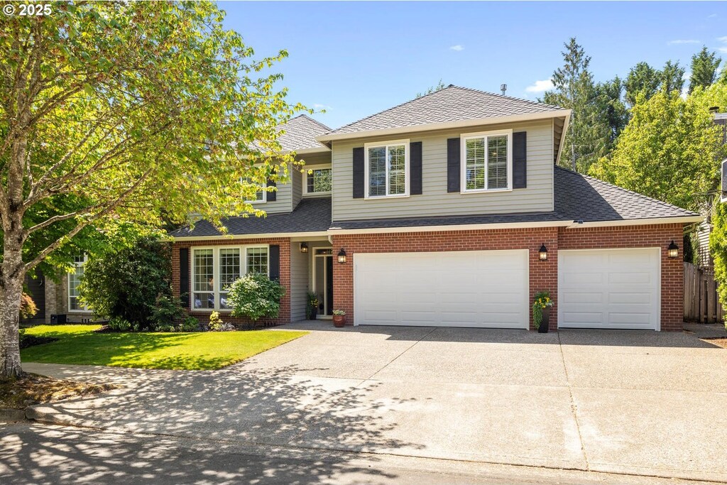 4860 Hastings Dr, Lake Oswego, OR 97035 - traditional home featuring concrete driveway, a shingled roof, brick siding, and a front yard