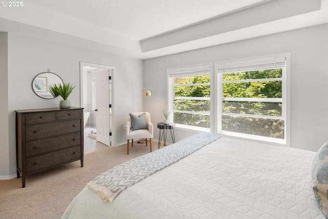bedroom with light carpet, multiple windows, and baseboards