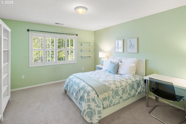 bedroom with carpet floors and baseboards