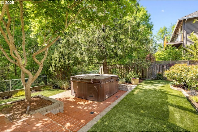 view of yard with a hot tub and a patio area