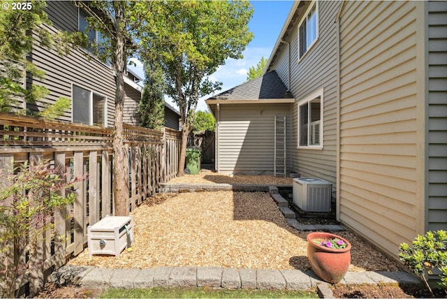 view of yard with cooling unit and fence
