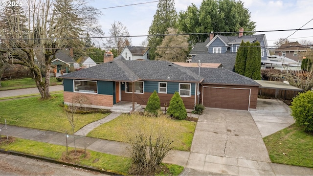 single story home featuring a shingled roof, a front yard, driveway, and an attached garage