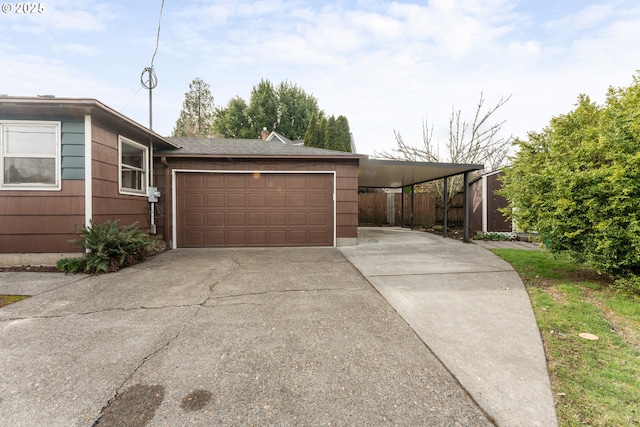 view of front of home featuring fence and concrete driveway