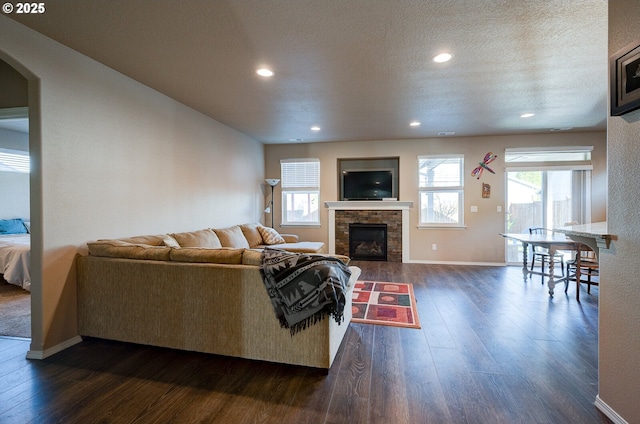 1531 Washington St, Independence, OR 97351 - living room with dark wood-type flooring, baseboards, a fireplace, recessed lighting, and arched walkways