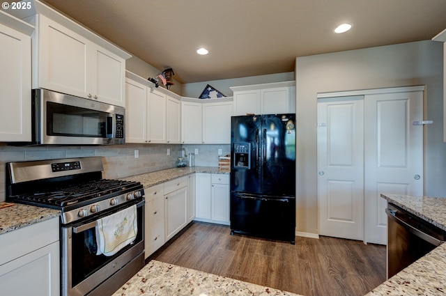 1531 Washington St, Independence, OR 97351 - kitchen with black appliances, dark wood finished floors, white cabinetry, backsplash, and recessed lighting