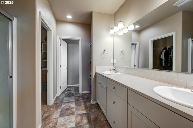 1531 Washington St, Independence, OR 97351 - full bath featuring a walk in closet, double vanity, baseboards, recessed lighting, and stone finish floors