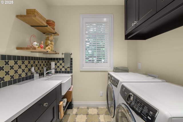 laundry room with cabinet space, washing machine and clothes dryer, and baseboards