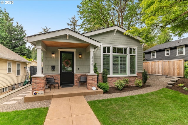 view of front of property featuring covered porch and brick siding