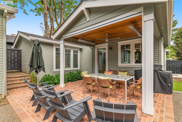 view of patio featuring outdoor dining area, ceiling fan, and area for grilling