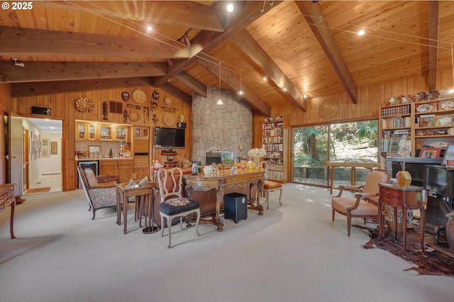 interior space with beam ceiling, high vaulted ceiling, wood ceiling, and wood walls