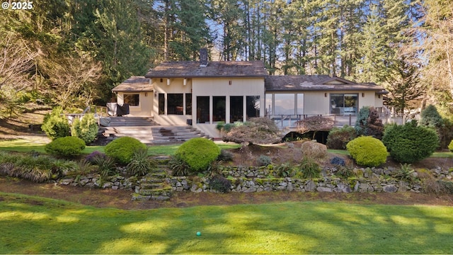 back of house with a yard and a wooden deck