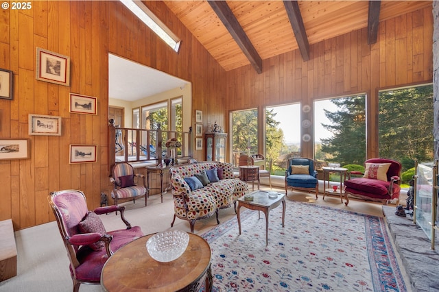 living room with beam ceiling, wood walls, high vaulted ceiling, and carpet floors