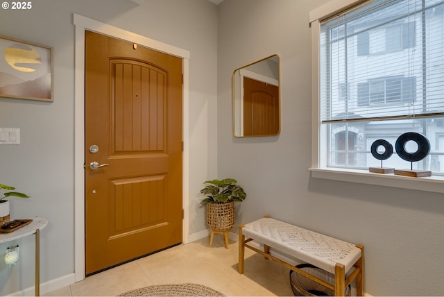 entrance foyer featuring light tile patterned floors and baseboards