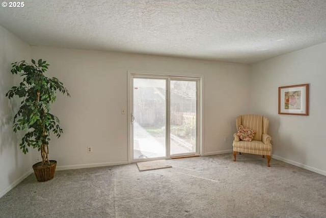 unfurnished room featuring carpet flooring, baseboards, and a textured ceiling