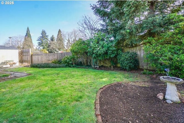 view of yard with a fenced backyard