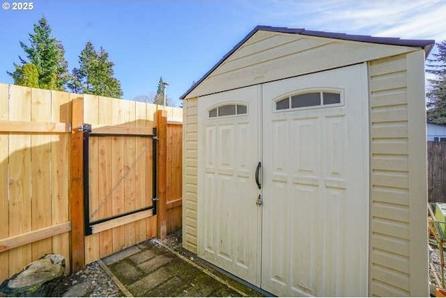 view of shed featuring fence