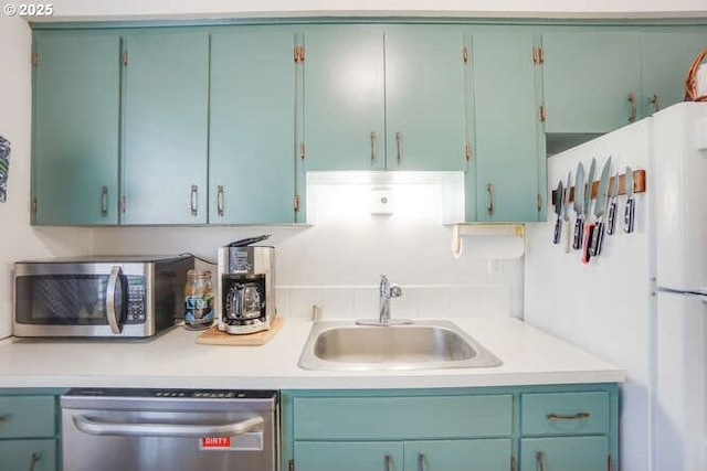 kitchen featuring light countertops, appliances with stainless steel finishes, and a sink