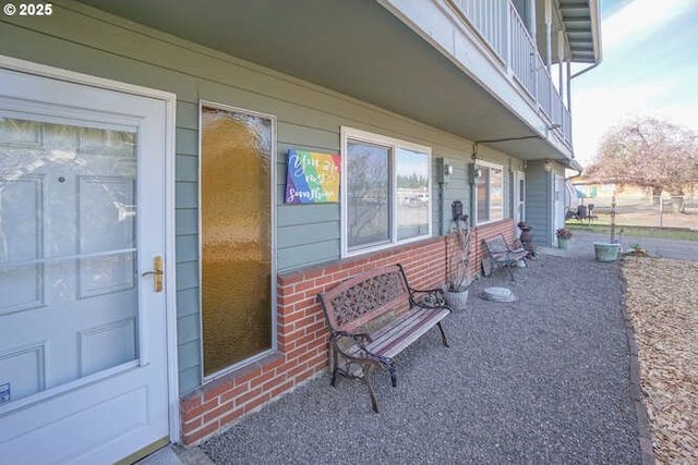 doorway to property featuring brick siding