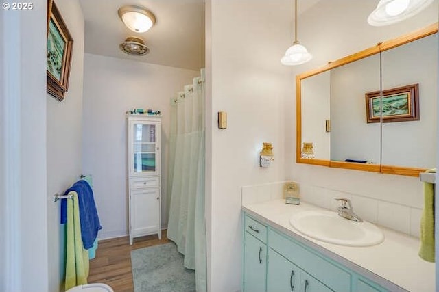 full bathroom with wood finished floors and vanity