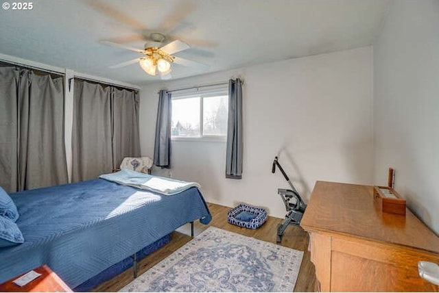 bedroom featuring ceiling fan and wood finished floors