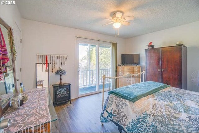 bedroom with ceiling fan, access to exterior, wood finished floors, and a textured ceiling