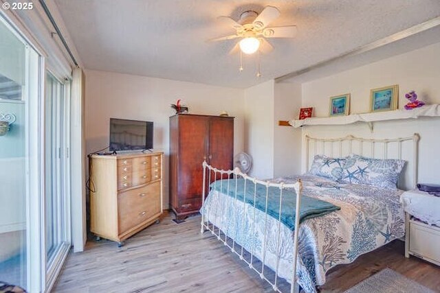 bedroom with ceiling fan and wood finished floors