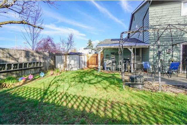 view of yard featuring a fenced backyard, an outbuilding, and a storage shed