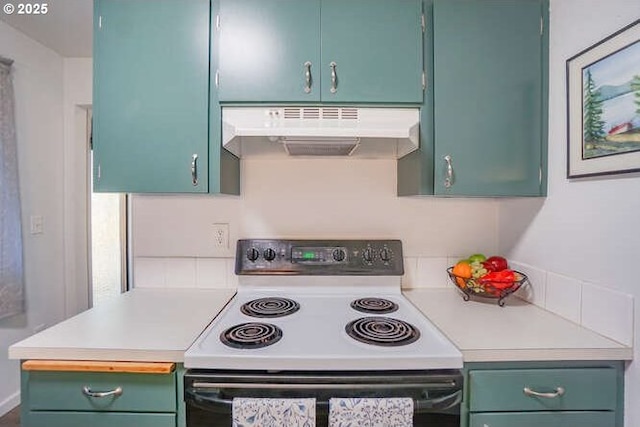 kitchen featuring under cabinet range hood, range with electric cooktop, light countertops, and green cabinets