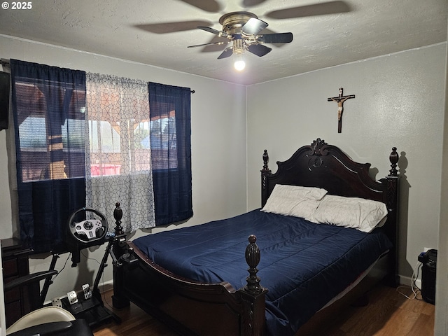 bedroom featuring wood finished floors and a ceiling fan