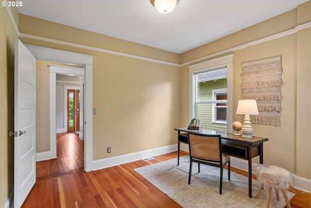 office space with baseboards and wood finished floors