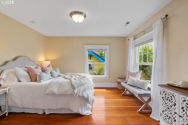 bedroom with light wood-style floors and baseboards