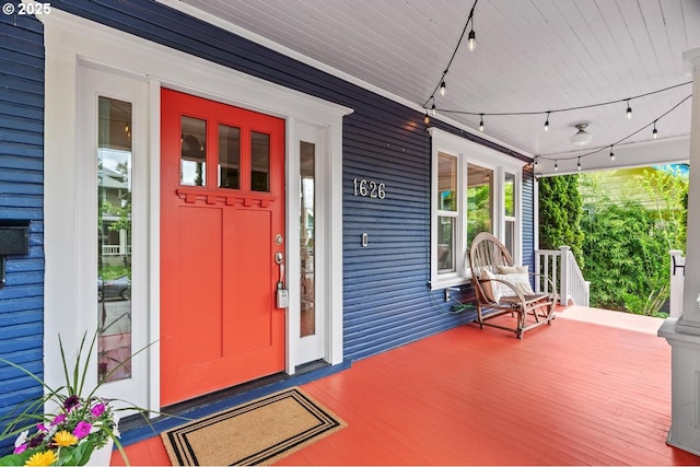 view of exterior entry featuring a porch