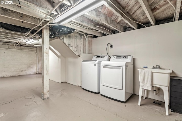unfinished below grade area with washer and clothes dryer