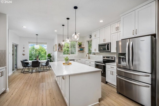 8427 NW Timber Ridge Ct, Portland, OR 97229 - kitchen with stainless steel appliances, open shelves, a sink, white cabinets, and light countertops