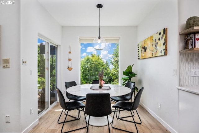 8427 NW Timber Ridge Ct, Portland, OR 97229 - dining space with light wood-style flooring, plenty of natural light, and baseboards