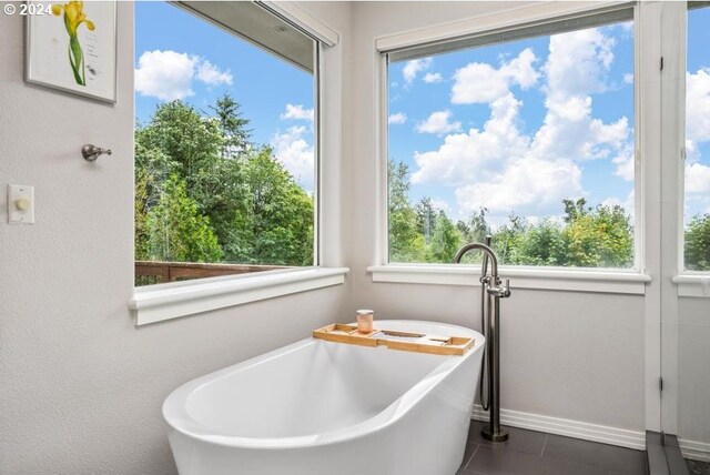 8427 NW Timber Ridge Ct, Portland, OR 97229 - full bath with a freestanding bath, tile patterned flooring, and baseboards