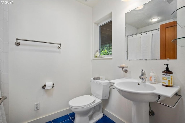 8427 NW Timber Ridge Ct, Portland, OR 97229 - bathroom featuring toilet, baseboards, and tile patterned flooring