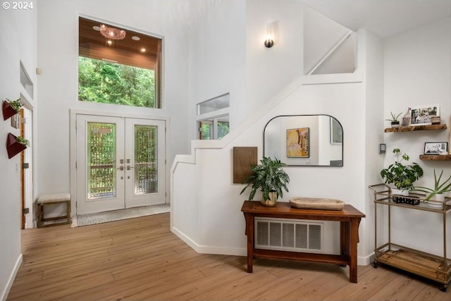 8427 NW Timber Ridge Ct, Portland, OR 97229 - foyer entrance featuring a towering ceiling, french doors, hardwood / wood-style flooring, and baseboards